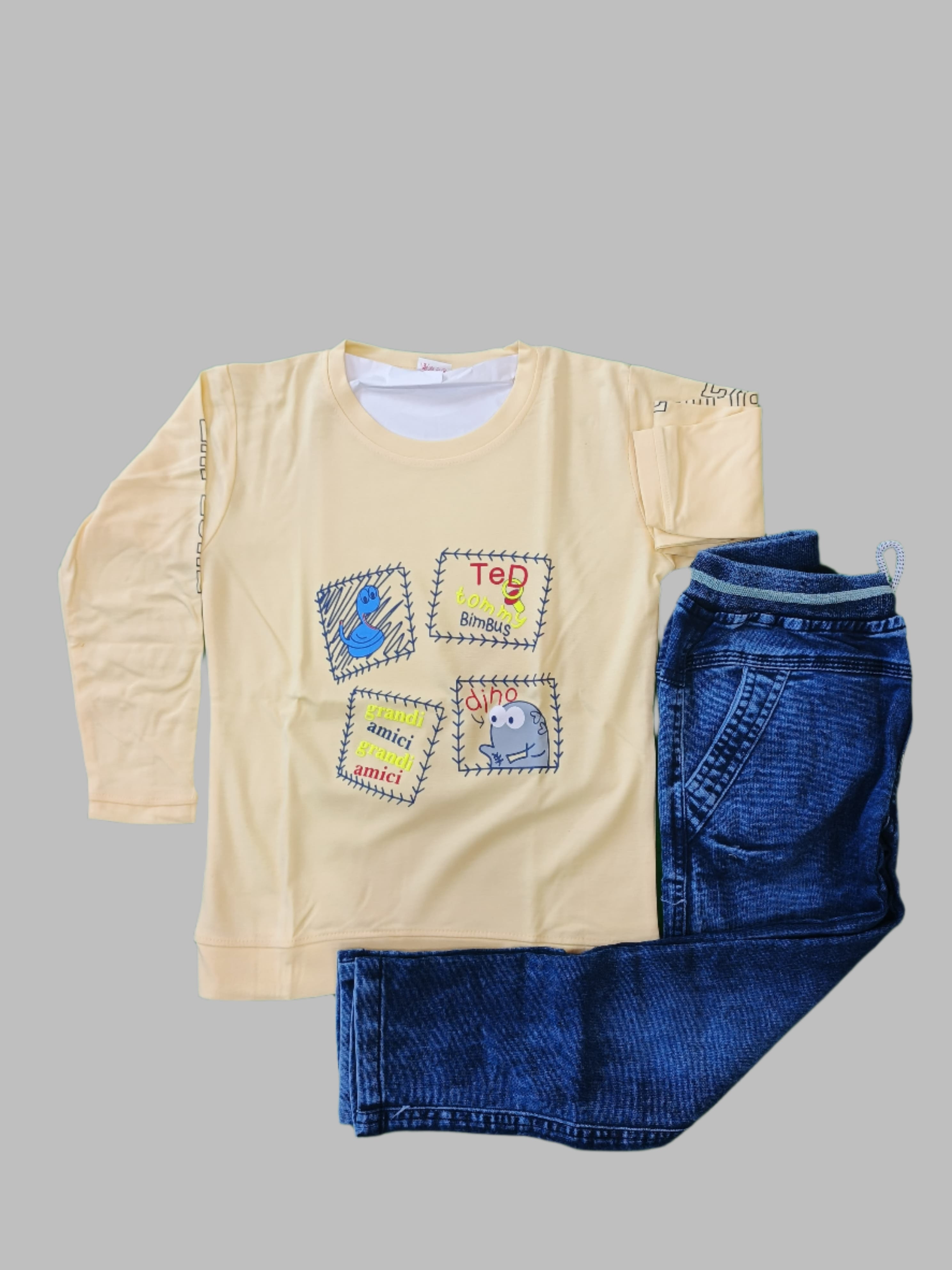 Beige long-sleeve shirt with embroidered designs and blue jeans on a green background