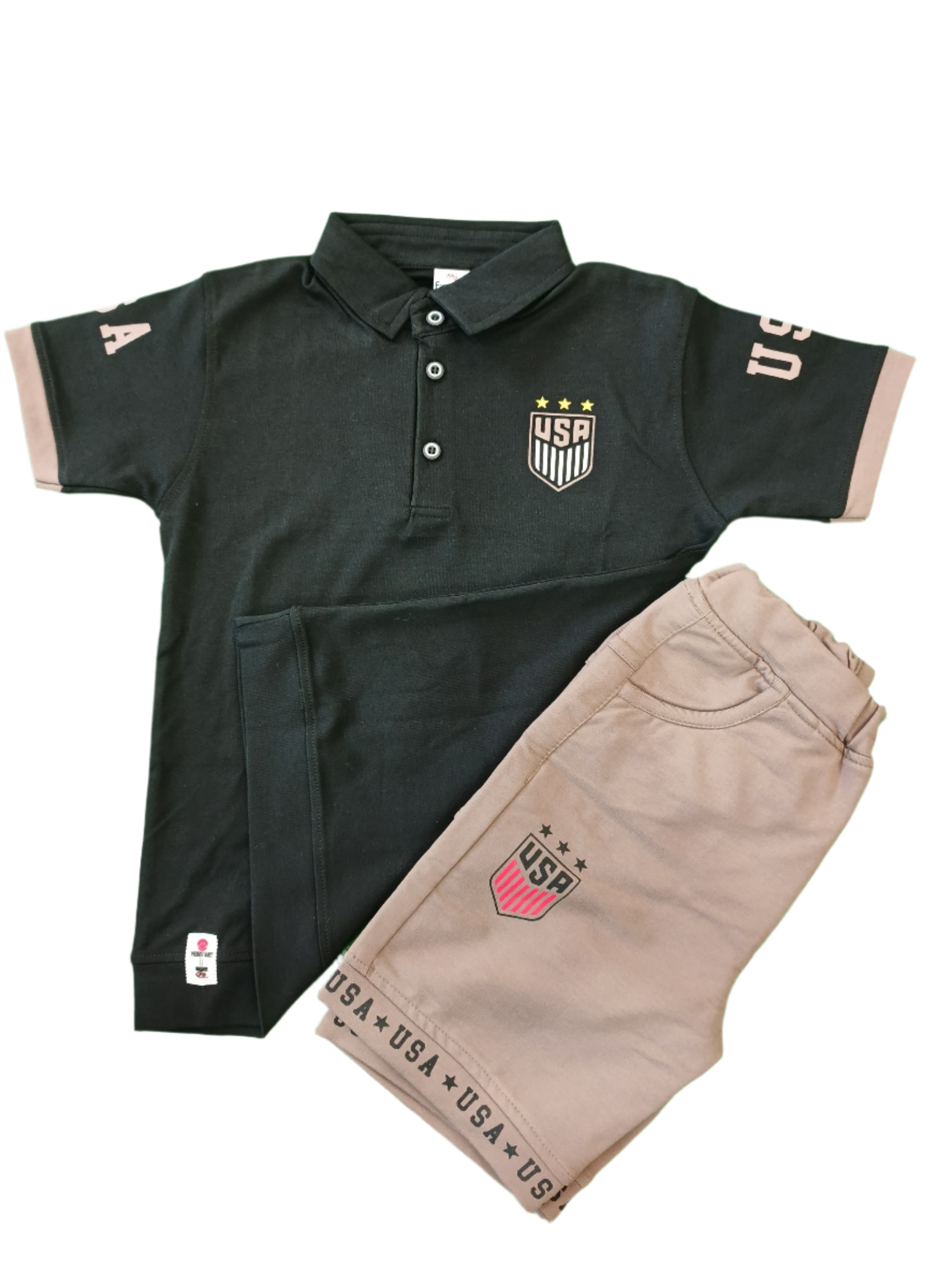 Black and beige pants with USA branding on a green background