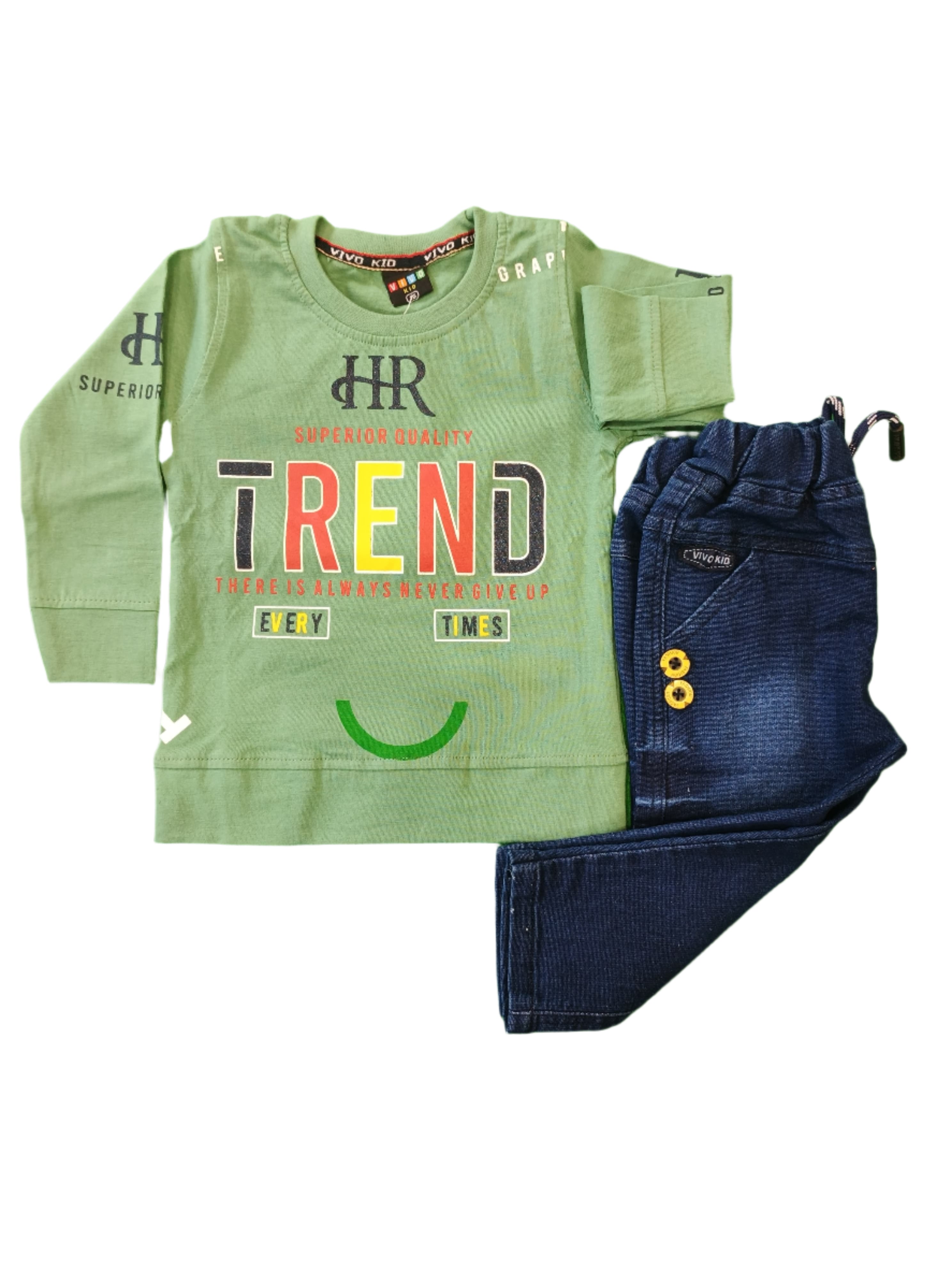 Folded green hoodie with text and blue jeans on a green surface