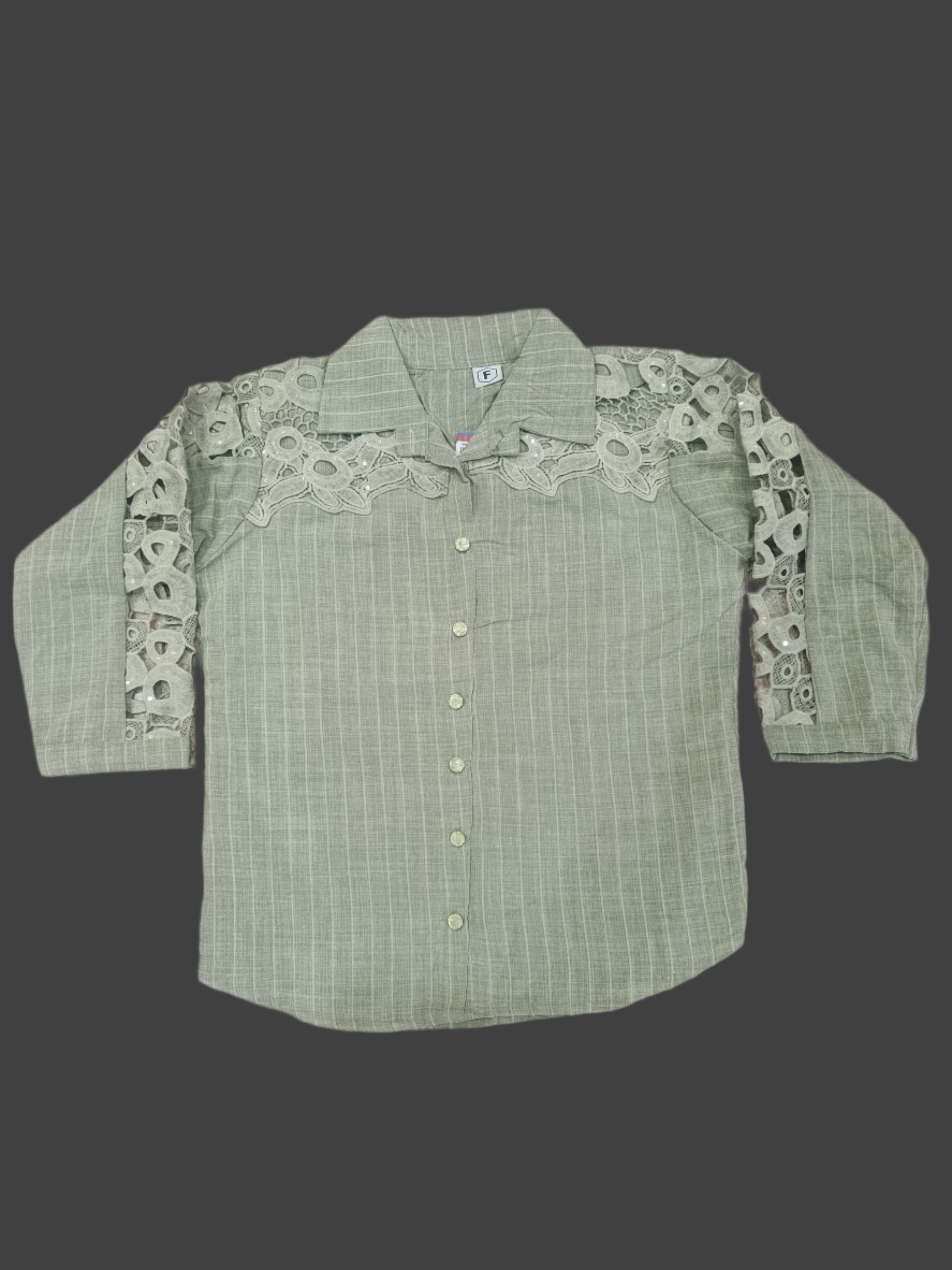 Green shirt with lace details on a marble floor