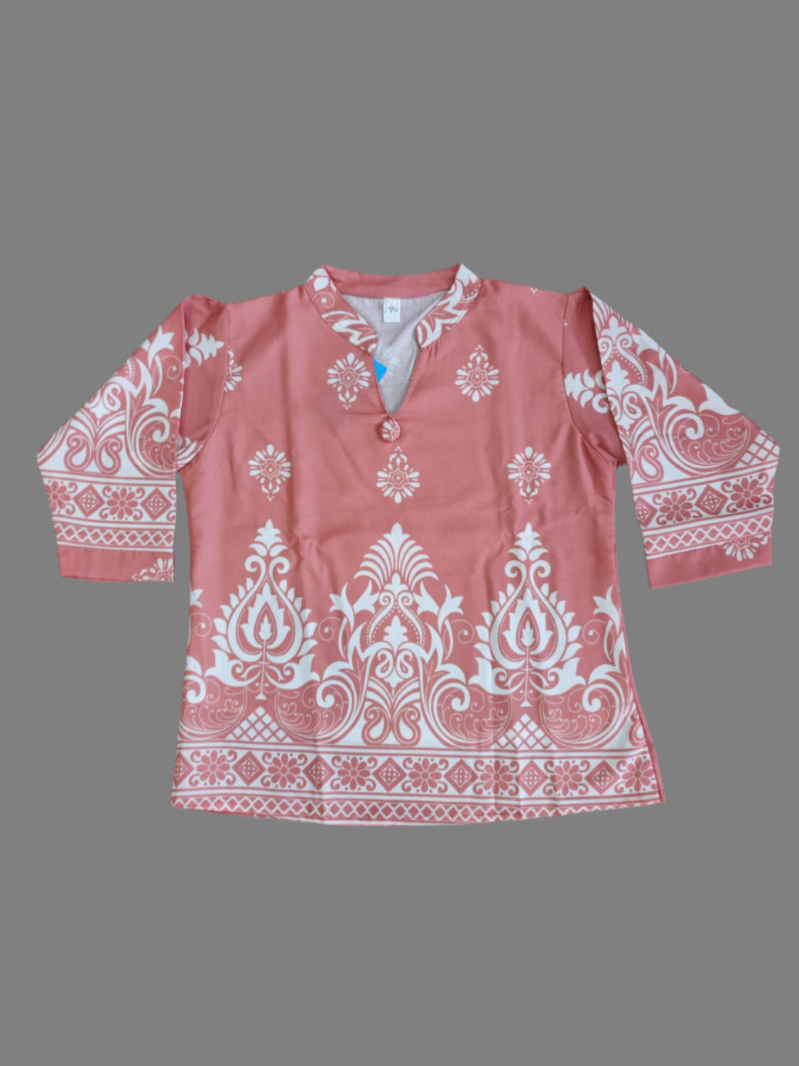 Red garment with white patterns on a tiled floor