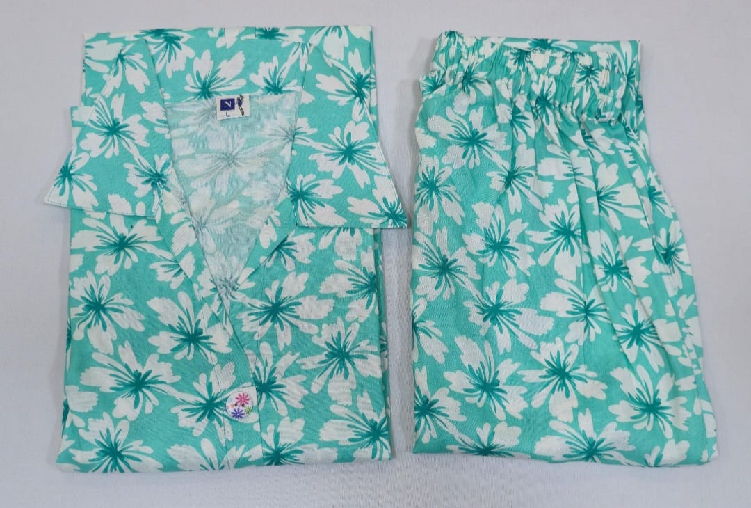 Teal and white floral pajama set on a light gray background