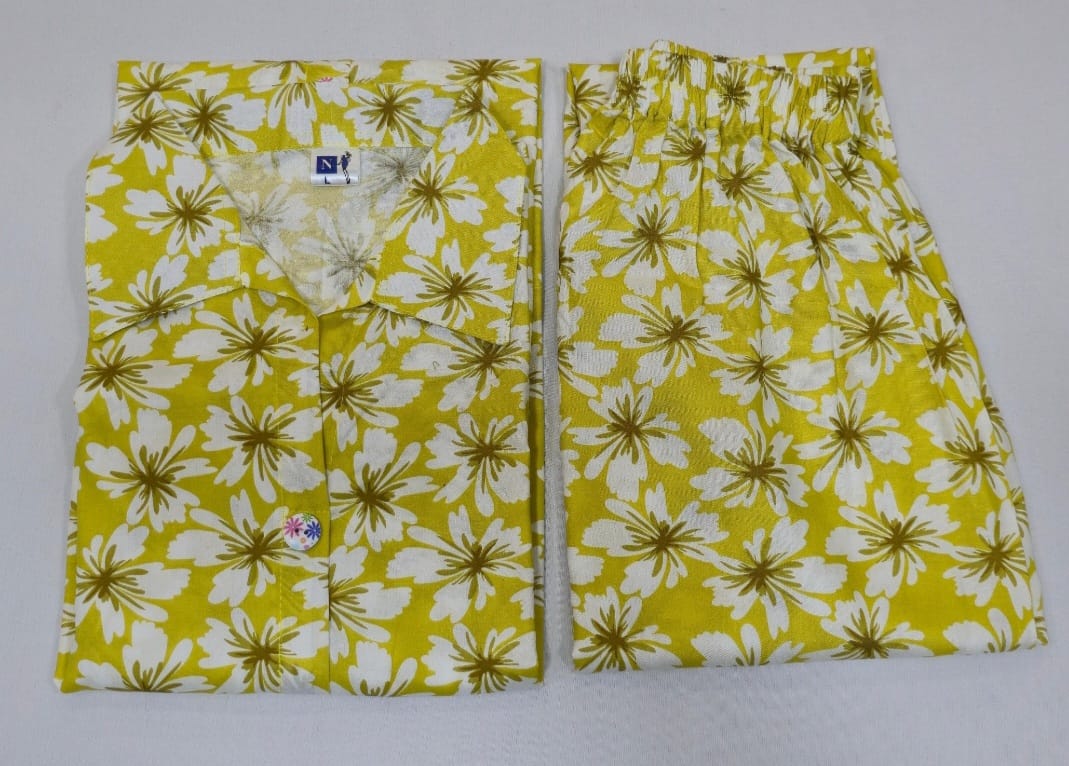 Yellow and white floral patterned shorts on a gray background