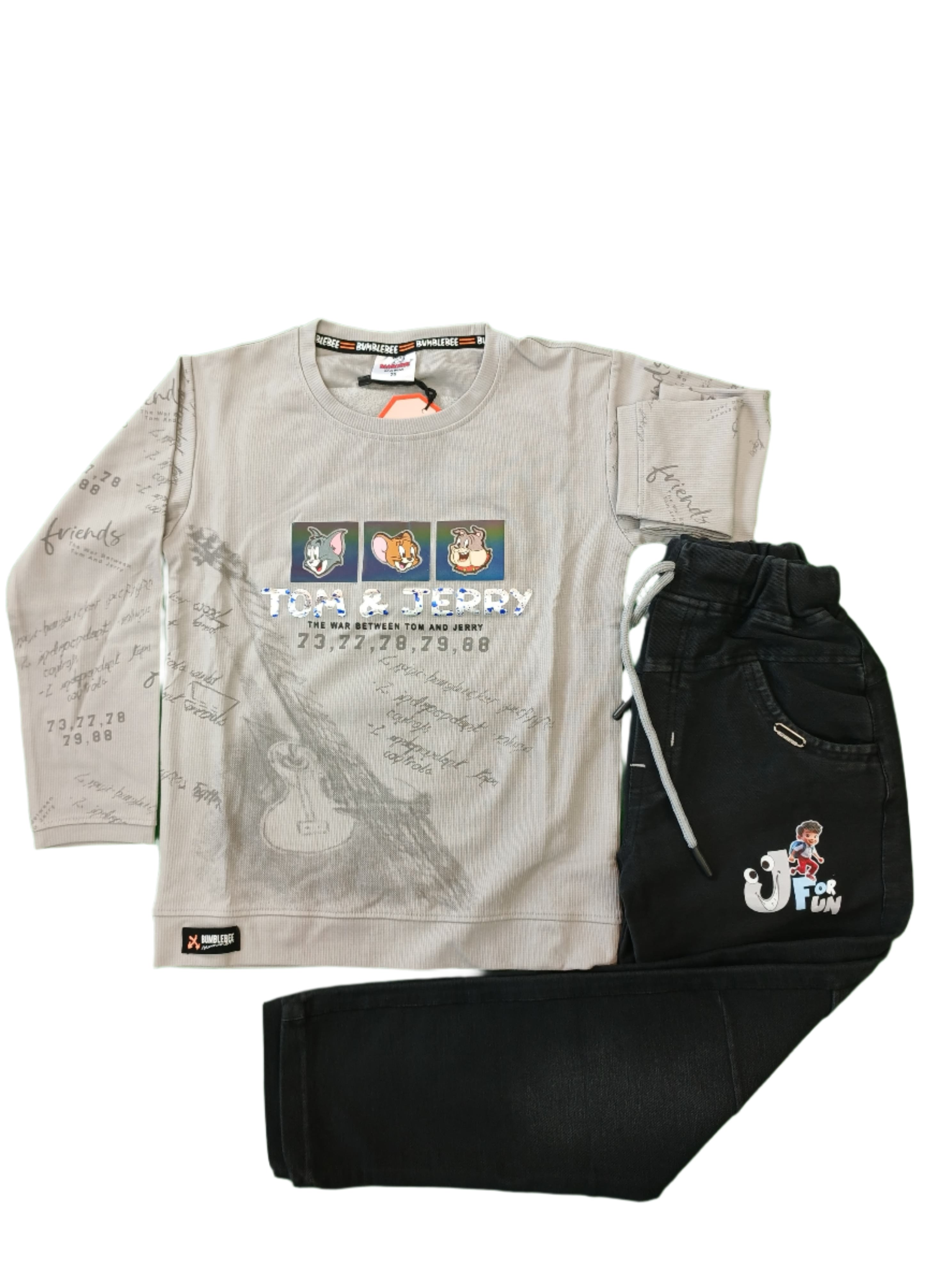 White long-sleeve shirt with graphics and black gloves on a green surface
