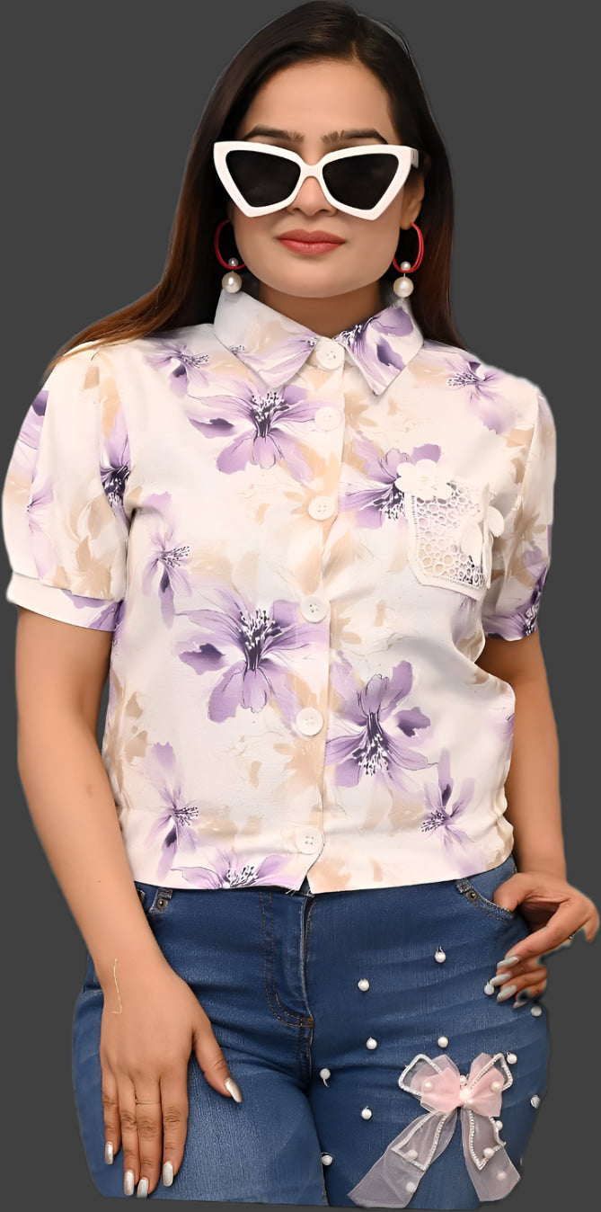 Woman wearing a floral blouse and denim shorts on a black background